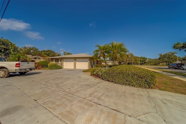 501 Poinsettia Rd, Belleair, FL 33756 - ranch-style house with a garage and driveway