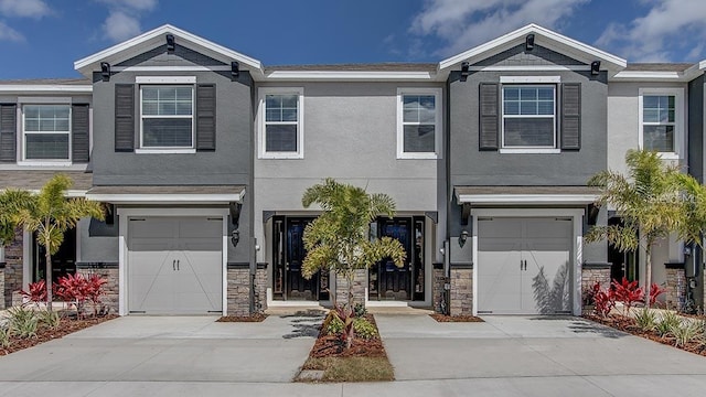 4444 Aqua Mirage St, Sarasota, FL 34238 - multi unit property featuring concrete driveway, an attached garage, stucco siding, and stone siding