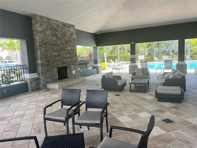 4444 Aqua Mirage St, Sarasota, FL 34238 - view of patio featuring an outdoor stone fireplace and a community pool