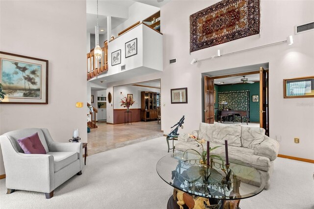 3133 Harvest Moon Dr, Palm Harbor, FL 34683 - carpeted living room featuring a towering ceiling and ceiling fan