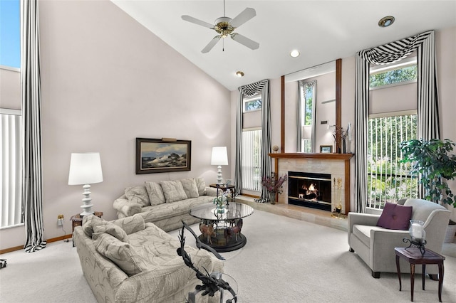 3133 Harvest Moon Dr, Palm Harbor, FL 34683 - carpeted living room featuring high vaulted ceiling, a tile fireplace, a ceiling fan, and recessed lighting