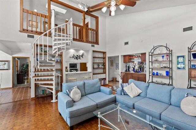 3133 Harvest Moon Dr, Palm Harbor, FL 34683 - living area featuring a towering ceiling, stairs, and ceiling fan