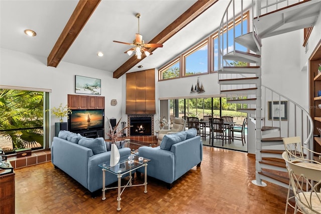 3133 Harvest Moon Dr, Palm Harbor, FL 34683 - living room with stairs, high vaulted ceiling, a warm lit fireplace, a ceiling fan, and beam ceiling