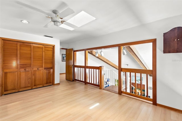 3133 Harvest Moon Dr, Palm Harbor, FL 34683 - hall with light wood-style floors, a skylight, and recessed lighting