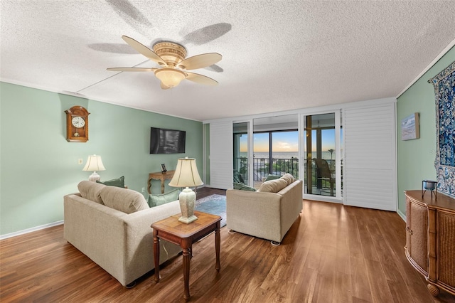 1581 Gulf Blvd Unit 403N, Clearwater Beach, FL 33767 - living room with a textured ceiling, a ceiling fan, wood finished floors, and baseboards