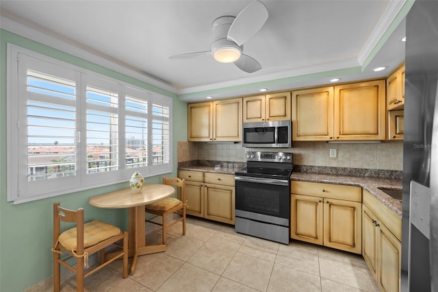 1581 Gulf Blvd Unit 403N, Clearwater Beach, FL 33767 - kitchen with stainless steel appliances, crown molding, backsplash, light tile patterned floors, and ceiling fan