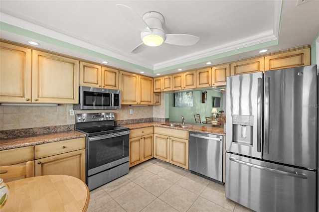 1581 Gulf Blvd Unit 403N, Clearwater Beach, FL 33767 - kitchen with stainless steel appliances, a tray ceiling, light tile patterned floors, recessed lighting, and a sink