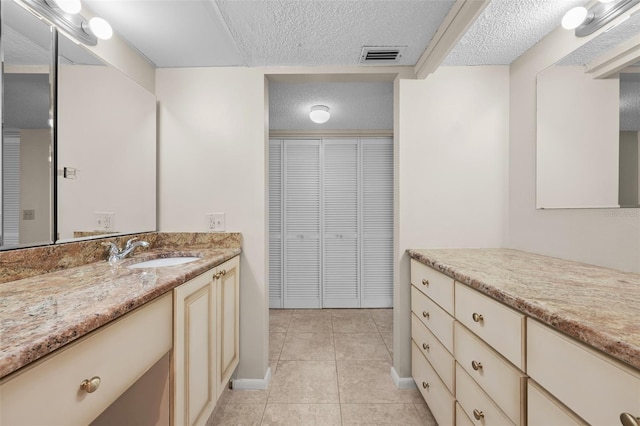 1581 Gulf Blvd Unit 403N, Clearwater Beach, FL 33767 - bathroom featuring a textured ceiling, vanity, tile patterned floors, a closet, and baseboards