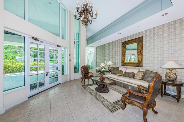 1 Seaside Ln Unit 302, Belleair, FL 33756 - tiled living room featuring healthy amount of natural light, wallpapered walls, a chandelier, and french doors