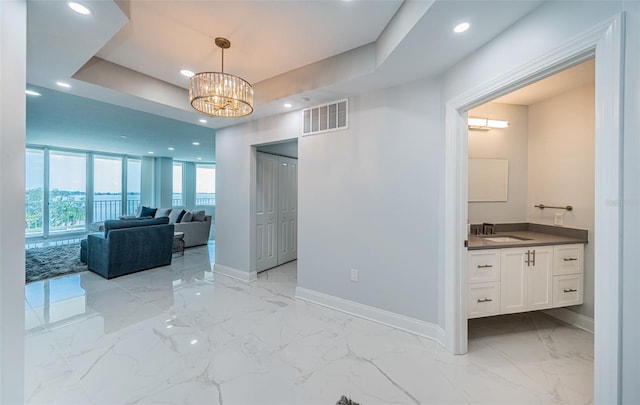 1 Seaside Ln Unit 302, Belleair, FL 33756 - hall with a chandelier, light marble finish flooring, and recessed lighting