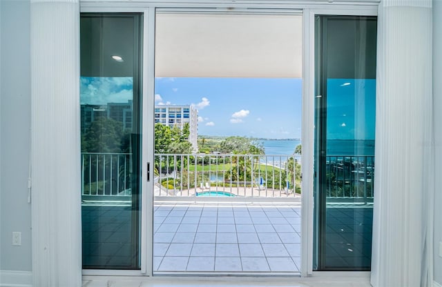 1 Seaside Ln Unit 302, Belleair, FL 33756 - doorway to outside with a water view and tile patterned floors