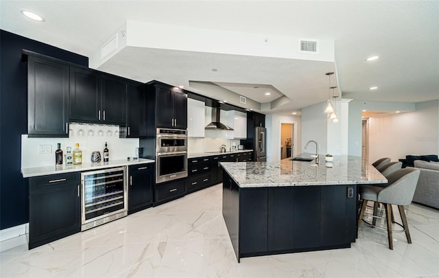 1 Seaside Ln Unit 302, Belleair, FL 33756 - kitchen with beverage cooler, dark cabinetry, stainless steel appliances, light marble finish flooring, and recessed lighting