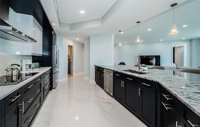 1 Seaside Ln Unit 302, Belleair, FL 33756 - kitchen featuring appliances with stainless steel finishes, wall chimney range hood, dark cabinets, light marble finish floors, and decorative light fixtures