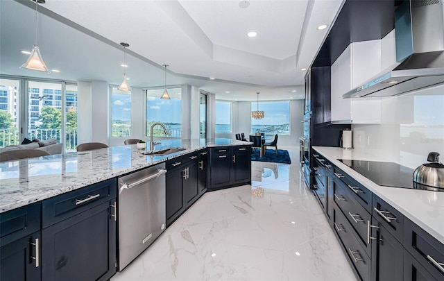 1 Seaside Ln Unit 302, Belleair, FL 33756 - kitchen with wall chimney range hood, stainless steel dishwasher, black electric stovetop, pendant lighting, and light stone counters