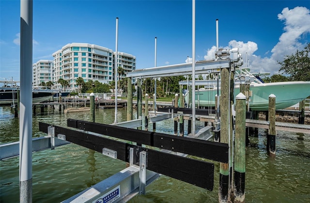 1 Seaside Ln Unit 302, Belleair, FL 33756 - dock featuring boat lift and a water view