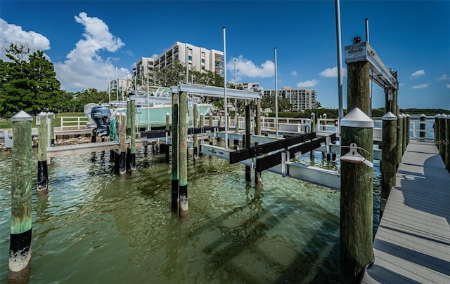 1 Seaside Ln Unit 302, Belleair, FL 33756 - dock area featuring boat lift and a water view
