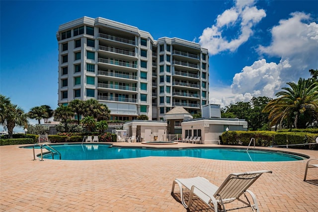 1 Seaside Ln Unit 302, Belleair, FL 33756 - community pool featuring a patio area and a hot tub