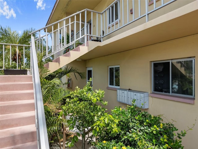 2003 Greenbriar Blvd Unit 1, Clearwater, FL 33763 - view of property exterior with stairs, stucco siding, and mail area