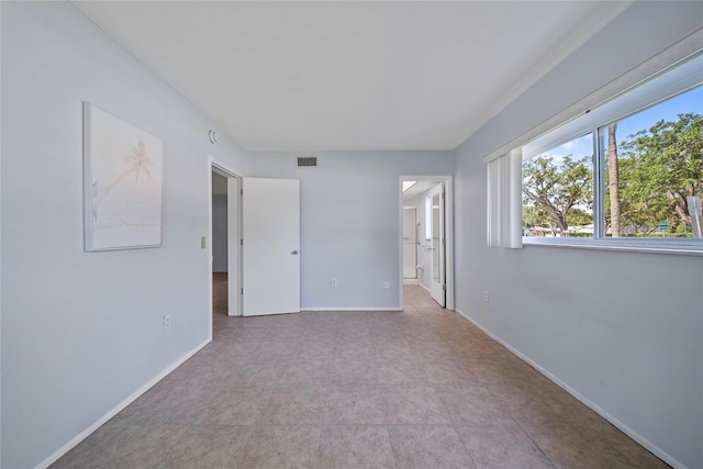2003 Greenbriar Blvd Unit 1, Clearwater, FL 33763 - unfurnished bedroom featuring baseboards and connected bathroom