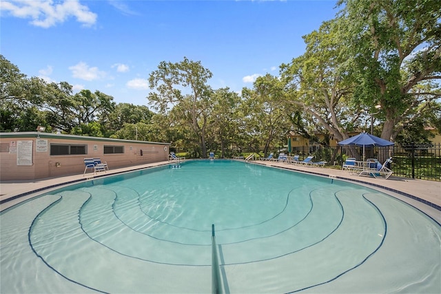 2003 Greenbriar Blvd Unit 1, Clearwater, FL 33763 - community pool featuring a patio area and view of scattered trees