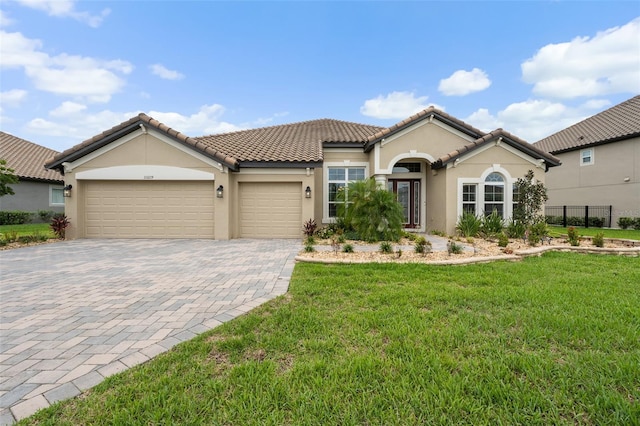 33219 Kateland Dr, Wesley Chapel, FL 33545 - mediterranean / spanish house with stucco siding, an attached garage, decorative driveway, and a tile roof