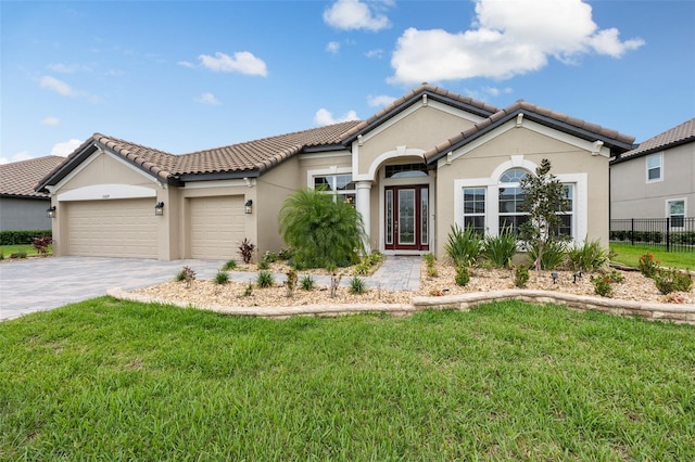 33219 Kateland Dr, Wesley Chapel, FL 33545 - mediterranean / spanish home with a garage, stucco siding, decorative driveway, and a tile roof