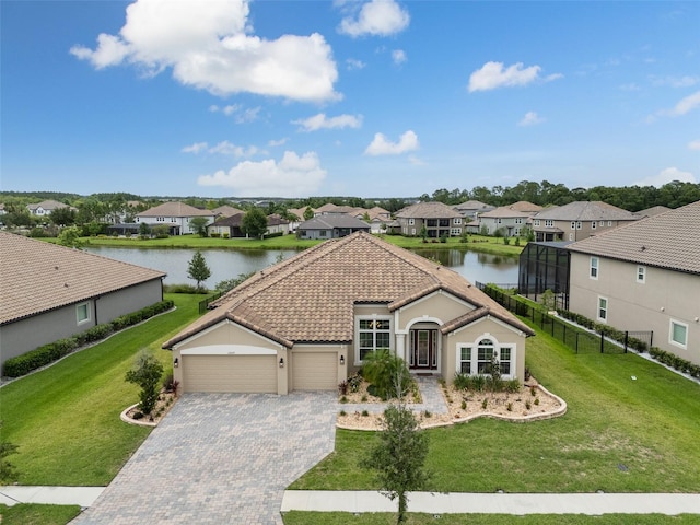 33219 Kateland Dr, Wesley Chapel, FL 33545 - view of front of home with a residential view, a water view, an attached garage, decorative driveway, and a tiled roof