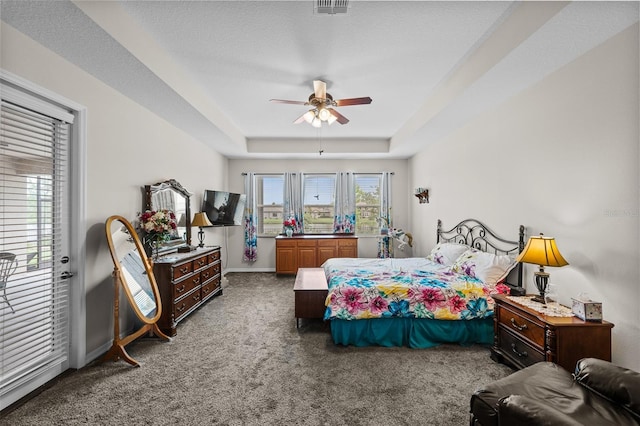 33219 Kateland Dr, Wesley Chapel, FL 33545 - carpeted bedroom with a tray ceiling, ceiling fan, and baseboards