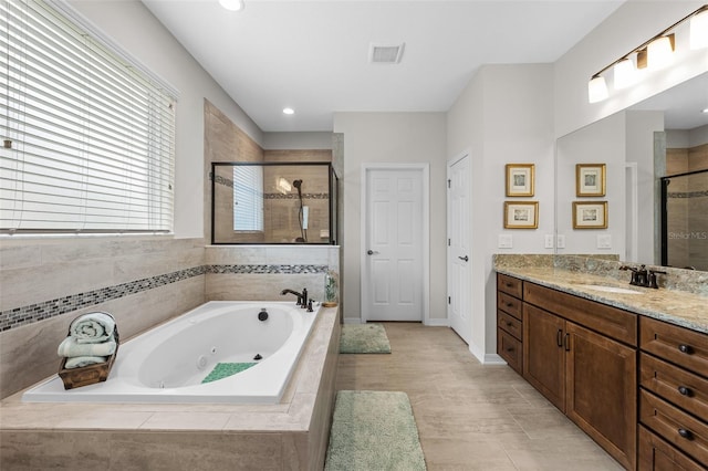 33219 Kateland Dr, Wesley Chapel, FL 33545 - full bathroom with a shower stall, a whirlpool tub, vanity, recessed lighting, and baseboards