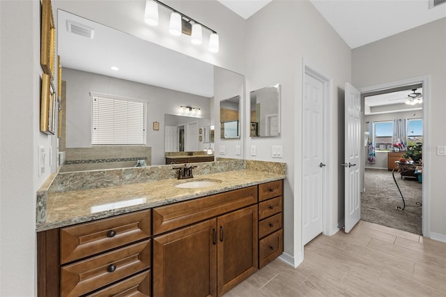 33219 Kateland Dr, Wesley Chapel, FL 33545 - bathroom with vanity, a ceiling fan, and baseboards