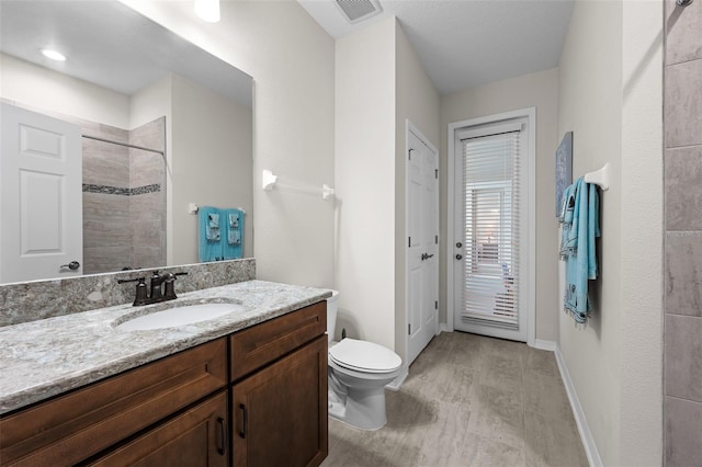33219 Kateland Dr, Wesley Chapel, FL 33545 - bathroom with toilet, vanity, tiled shower, and baseboards