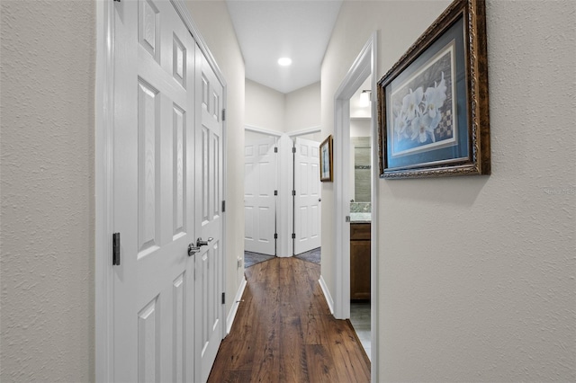 33219 Kateland Dr, Wesley Chapel, FL 33545 - corridor with dark wood-type flooring, a textured wall, recessed lighting, and baseboards