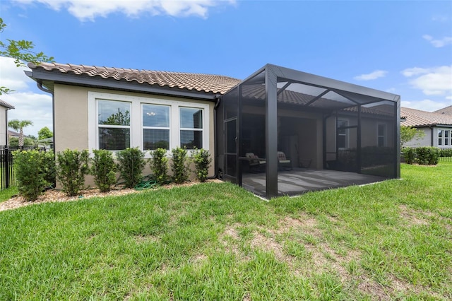 33219 Kateland Dr, Wesley Chapel, FL 33545 - rear view of house featuring a tile roof, stucco siding, a patio, and glass enclosure