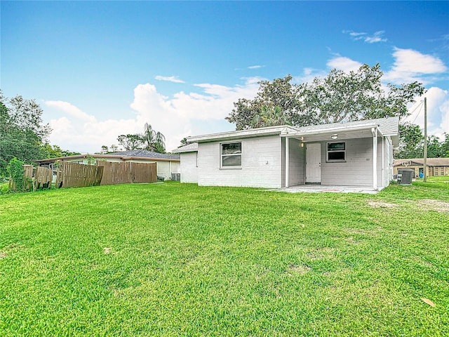 8329 Gulf Way, Hudson, FL 34667 - back of house featuring cooling unit, concrete block siding, and a carport