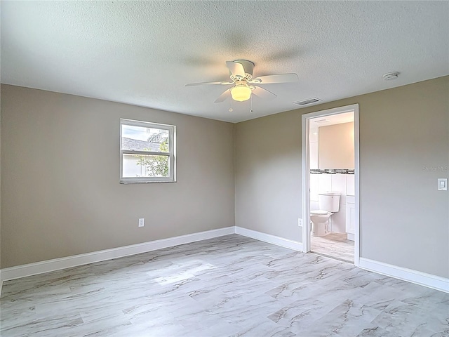 8329 Gulf Way, Hudson, FL 34667 - empty room with ceiling fan, a textured ceiling, baseboards, and a smoke detector