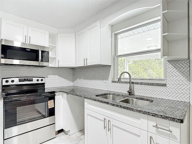 8329 Gulf Way, Hudson, FL 34667 - kitchen featuring stainless steel appliances, open shelves, a sink, tasteful backsplash, and a textured ceiling