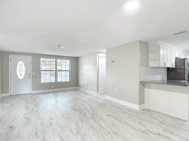 8329 Gulf Way, Hudson, FL 34667 - unfurnished living room with light marble finish flooring and baseboards