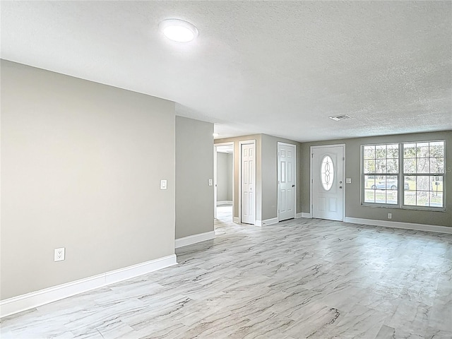 8329 Gulf Way, Hudson, FL 34667 - entrance foyer with a textured ceiling and baseboards