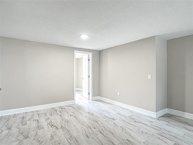 8329 Gulf Way, Hudson, FL 34667 - unfurnished room with a textured ceiling and baseboards