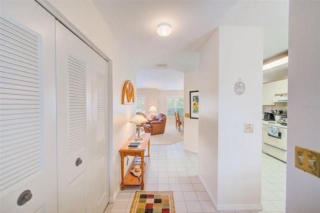 7823 Hardwick Dr Unit 224, New Port Richey, FL 34653 - corridor with light tile patterned flooring and baseboards