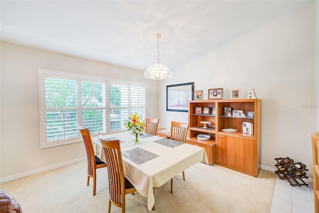 7823 Hardwick Dr Unit 224, New Port Richey, FL 34653 - dining space featuring healthy amount of natural light, baseboards, light carpet, and a chandelier