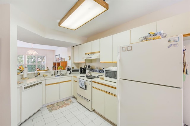 7823 Hardwick Dr Unit 224, New Port Richey, FL 34653 - kitchen featuring white appliances, under cabinet range hood, a sink, light countertops, and light tile patterned floors