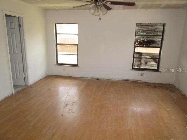 5190 Starling Dr, Mulberry, FL 33860 - empty room with light wood finished floors and a ceiling fan