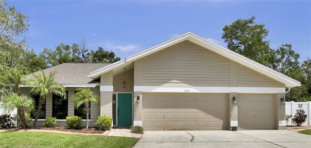 12219 Steppingstone Blvd, Tampa, FL 33635 - mid-century home featuring a garage, concrete driveway, and brick siding