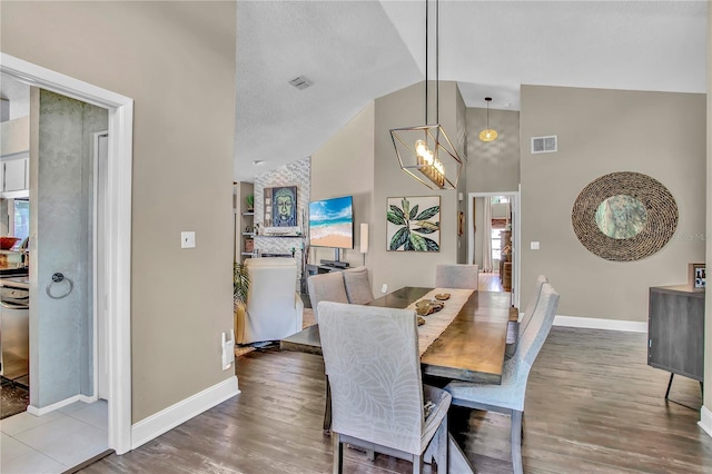 12219 Steppingstone Blvd, Tampa, FL 33635 - dining space with baseboards, wood finished floors, high vaulted ceiling, and a chandelier