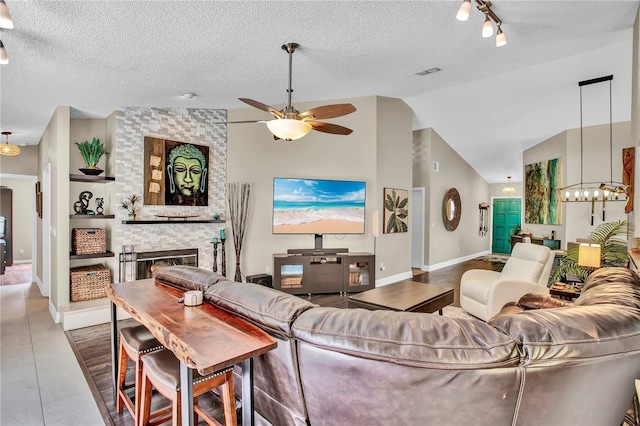 12219 Steppingstone Blvd, Tampa, FL 33635 - living area with a ceiling fan, a large fireplace, vaulted ceiling, a chandelier, and a textured ceiling
