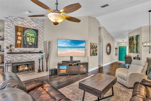 12219 Steppingstone Blvd, Tampa, FL 33635 - living room featuring vaulted ceiling, ceiling fan, wood finished floors, a fireplace, and baseboards