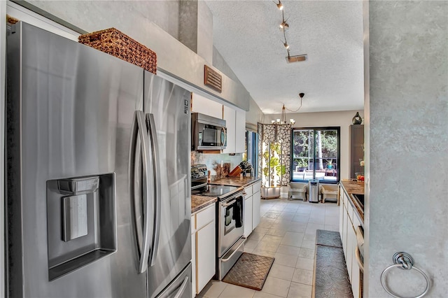 12219 Steppingstone Blvd, Tampa, FL 33635 - kitchen featuring stainless steel appliances, a textured ceiling, a chandelier, white cabinets, and light tile patterned flooring