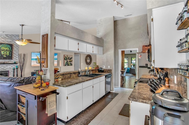 12219 Steppingstone Blvd, Tampa, FL 33635 - kitchen featuring track lighting, a towering ceiling, dishwasher, white cabinetry, and a ceiling fan