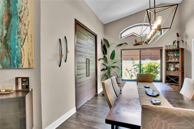 12219 Steppingstone Blvd, Tampa, FL 33635 - dining space with a chandelier, baseboards, dark wood-type flooring, and vaulted ceiling